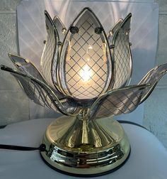 a decorative glass and metal lamp on a table