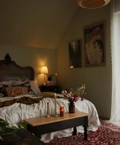 a bed room with a neatly made bed next to a window