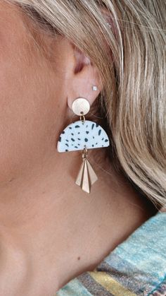 a close up of a person wearing some kind of earrings