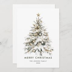 a white christmas card with a watercolor painting of a tree and ornaments on it