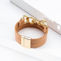 Add this stylish magnetic bracelet to your collection. Coordinate with gold jewelry or wear it alone as a statement piece. Order today and enjoy fast shipping. Adjustable Gold Leather Bracelet Chic Style, Adjustable Gold Leather Chic Bracelet, Brown Bangle Bracelet For Fashion, Trendy Gold Leather Bracelet, Trendy Brown Metal Bracelets, Elegant Brown Metal Cuff Bracelet, Elegant Brown Leather Bracelet, Elegant Bracelets With Magnetic Closure For Gift, Elegant Gold Magnetic Bracelets