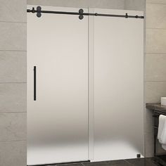 a bathroom with a glass sliding shower door