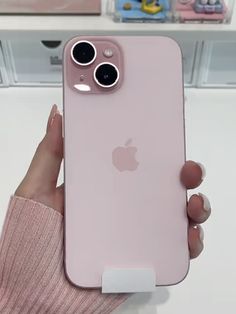 a person holding an iphone in their hand with the camera on it's back