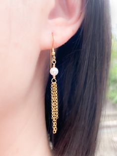 If you like the combination of yellow gold and white pearls, then these earrings are perfect for you! Simple and elegant, fun and flirty. Wear it dressed up or down. Super lightweight! MATERIALGold filled chainWhite Swarovski crystal pearlsGold filled ear wiresSIZE5mm crystal pearls1.75 inches length (excluding ear wires)WHAT IS GOLD FILLED?We used to have just 2 choices: pure gold or gold plated. The first was very expensive, and the second was…well…not very good.Our gold filled jewelry is desi Hypoallergenic Gold Pearl Earrings For Party, Gold Dangle Pearl Earrings With Adjustable Chain, Gold Pearl Earrings With Adjustable Chain, Pearl Fringe, Swarovski Pearls, White Crystal, Fringe Earrings, Pure Gold, Crystal Pearls