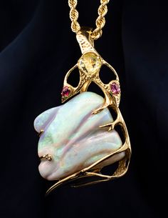 14K Yellow Gold Free Form Opal Pendant Large one of a kind opal pendant with beautiful fire shining throughout. This opal has green, purple, pink and orange fire and was mounted in the 80 or 90's.  Length of pendant: 87mm Width: 49mm Metal: 14 karat Yellow Gold  Stone: Opal at 80 grams. *Chain Sold Separately Fine Jewelry Ethiopian Opal Pendant, Opal Large Pendant Jewelry, Luxury Unique Opal Necklace, Luxury Artisan Opal Necklaces, Opal Multi-stone Pendant Necklace, Elven Jewelry, Opal Pendants, Opal Jewelry, Pink And Orange