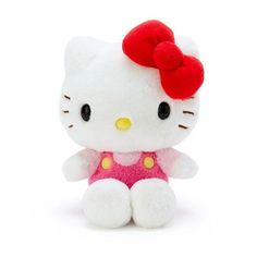 a hello kitty stuffed animal with a red bow on it's head sitting down