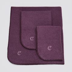 two pieces of purple wool sitting on top of each other