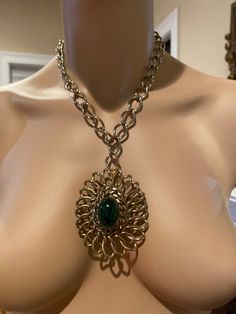 Very good vintage condition. 18 inch chain 1.5 inch dark green cabochon no flaws noted Entire pendant is 3 in in length. Unsigned piece Metal Oval Pendant Necklace With Chain, Retro Metal Necklaces With Adjustable Chain, Retro Metal Necklace With Adjustable Chain, Vintage Handmade Metal Chain Necklace, Handmade Vintage Metal Chain Necklace, Green Medallion Necklace For Formal Occasions, Green Metal Chain Necklace With Adjustable Chain, Vintage Handmade Metal Medallion Necklace, Handmade Vintage Metal Medallion Necklace