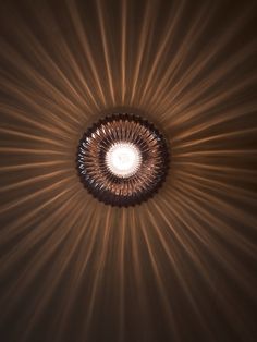 the light is shining down on the ceiling in the room with it's circular shape