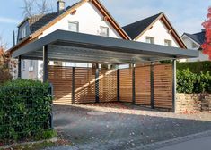 a house with a large wooden fence and gate in front of it that has the number 4a on it