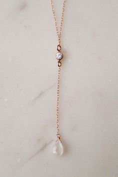 Our SKYE Moonstone Necklace is so dainty & beautiful! This dainty lariat necklace is made for the minimalist lovers who want something that they can wear on their special day without overpowering their entire look. The eye catching cubic zirconia and rainbow moonstone add an elegant touch to a classic look. ---------------------FEATURES◊ Your choice of material: 14k gold fill, rose gold fill, or sterling silver◊ Cubic zirconia (4mm) set in gold fill, rose gold fill, or sterling silver ◊ Hand Minimalist Long Drop Backdrop Necklace As Gift, Delicate Long Drop Backdrop Necklace, Minimalist Long Drop Backdrop Necklace For Gift, Delicate Rose Gold Lariat Necklace, Delicate Long Drop Necklace, Elegant Moonstone Clavicle Chain Jewelry, Minimalist Teardrop Jewelry For Weddings, Dainty Teardrop Backdrop Necklace As Gift, Minimalist Teardrop Wedding Jewelry