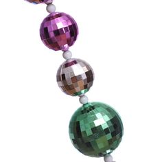 three disco ball ornaments hanging from a string on a white background with clippings