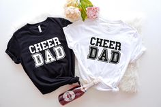 Cheer Dad T-Shirt | Cheerleading Dad Tee | Cheer Dad Apparel | Proud Cheer Dad Shirt | Father's Day Gift | Cheer Squad Dad Graphic Tee Our T-Shirts About our Shirts 1- Non-Heather T-Shirts are %100 cotton 2- Heather T-Shirts are %52 cotton %48 polyester 3- Shirts prints are making with high quality items About Size 1- To make sure about what size fits to you should look at the size chart 2- Our t-shirts fits unisex sizing 3- We have 7 size options and they are XS, S, M, L, XL, 2XL, 3XL Our Policy 1- We produce the shirts within 1- 3 days after get your order 2- Shipping process changes according to your choice 3- Priority shipping provide 2-3 business day shipping 4- First Class shipping provide 1-5 business day shipping About Order 1- Firstly, choose a size 2- Then, choose a primarily col Cheer Dad Shirt, Cheer Dad Shirts, Cheer Squad, Dad To Be Shirts, Cheerleading, Father's Day, Printed Shirts, Graphic Tee, Graphic Tees