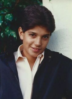 a young man wearing a white shirt and black jacket