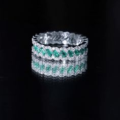 Product Details Delight in the enchanting allure of our Braided Ring, an irresistible accessory that will captivate your partners heart. This Wedding Band showcases Baguette Cut Created Emerald gemstones at its center, and the braided shank is adorned with the brilliance of Round Shape Moissanite, enhancing its beauty. Product Information SKU SHP-RINGS122036918 Width 2 mm Height 5 mm Weight 3.20 gm (Approximate) LAB CREATED EMERALD INFORMATION No.of Stones 22 Pieces Total Weight 1.32 Carat (Appr