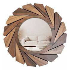 a mirror that is on the wall with some wood pieces around it and a couch in the background