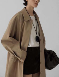 Easy chic long tan twill coat 55% cotton , 41% polyester, 4% spandex 100% polyester lining Fit is oversized Side pockets Button sleeve cuffBust 55"/145 cmTotal length 53"/135 cmModel wears one size and is 5.8"/170 cm Imported Beige Gabardine Outerwear With Button Cuffs, Brown Long Coat Outerwear For Everyday, Brown Long Coat For Everyday Wear, Oversized Outerwear With Button Cuffs For Work, Oversized Gabardine Outerwear With Pockets, Oversized Workwear Outerwear With Button Cuffs, Brown Long Coat For Everyday, Oversized Brown Outerwear For Everyday, Casual Gabardine Outerwear For Office