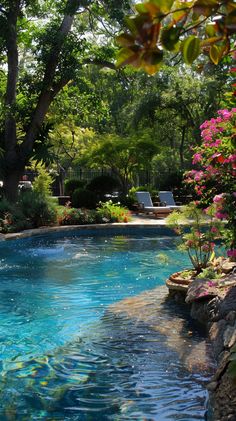 an outdoor swimming pool surrounded by trees and flowers