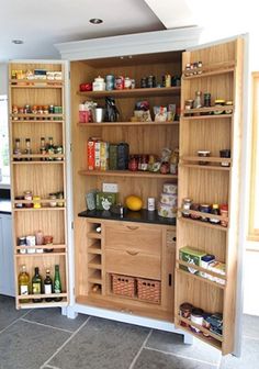 an open pantry in the middle of a kitchen with lots of food on it's shelves