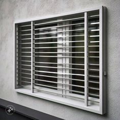 an image of a window that is closed on the side of a building with shutters