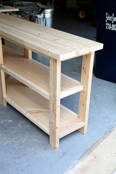 a wooden table sitting on top of a cement floor