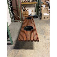 a wooden bench sitting inside of a warehouse