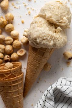 two scoops of ice cream sitting next to some nuts