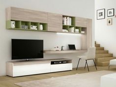 a modern living room with white furniture and green shelving units on the wall above it