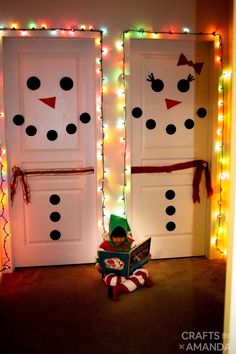 two snowman doors decorated with christmas lights