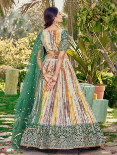 Introducing the stunning "great white & green shibori printed chinon lehenga choli with dupatta" from Ethnic Plus! This exquisite set features a white and green color combination, crafted from premium chinon material. The lehenga is adorned with intricate zari embroidered work, sequin work, and beautiful shibori print details, making it a show-stopping ensemble for weddings, festivals, and other ethnic occasions.
With its semi-stitched design, it can fit up to 42 inches and comes with an uns Green Bohemian Set With Traditional Drape, Bohemian Green Set With Traditional Drape, Bohemian Ikat Print Choli For Festive Occasions, Green Bohemian Batik Print Dupatta, Green Bohemian Silk Sets, Green Bohemian Semi-stitched Sets, Green Bohemian Sets For Transitional Season, Bohemian Green Sets For Transitional Season, Green Bohemian Transitional Sets