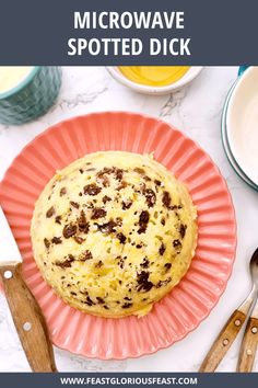 a close up of a muffin on a pink plate