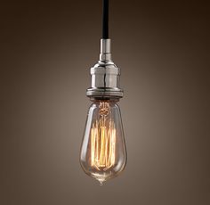 a light bulb hanging from the ceiling with no bulbs on it, in front of a brown background