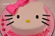 a hello kitty birthday cake with pink icing