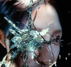 a woman's face is covered in crystal shards