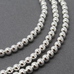 A gorgeous 4mm sterling silver bead necklace strand.  Made to order in the length you desire.  These shiny silver beads are hand strung on a sturdy beading wire with beautiful flex and drape. They close with a simple lobster clasp.  This necklace is sure to become a fast favorite!  Dress it up or dress it down, wear them everyday!• 4mm 925 Sterling Silver Beads (not plated)~  this is real heirloom quality 925 silver.  • Made to order in almost any length (if you length is not listed- just ask, I Silver Bead Necklace, Opal Bracelet, Green Opal, Beading Wire, Necklace Long, Silver Bead, Seed Bead Jewelry, Matching Bracelets, Shiny Silver