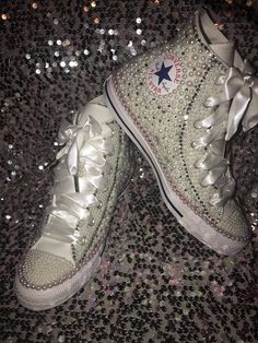 Converse with rhinestones crystals and pearls. Custom Made to order.... Bling Converse Sneakers. All designs handmade and embellished with a variety of high quality crystals. Great for weddings, proms, homecomings, birthdays, special events or just your everyday casual outing..You will turn heads Turnaround time is currently 3 weeks IF YOU NEED THIS SHOES BEFORE THE SHIPPING TIME YOU MUST CONTACT US BEFORE ORDERING (additional charges may apply) **  You can add Rush listing to your order to receive shoes within 1 week of ordering.  PLEASE NOTE CONVERSE SNEAKERS RUN ABOUT A WHOLE SIZE BIG. I STRONGLY RECOMMEND TRYING A PAIR ON TO INSURE CORRECT SIZE. ALL ORDERS COME AS SHOWN IN PICS FOR ALL CUSTOM COLOR DESIGNS EMAIL me at dazzlebytt@gmail.com or message on Etsy... Converse With Rhinestones, Bedazzled Converse, Bride Converse, Bling Converse, Converse Sneakers, Womens Tie, Tie Shoes, Eras Tour, 3 Weeks