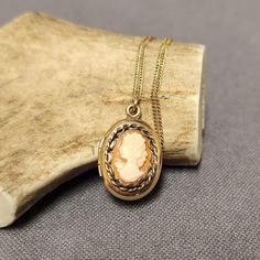 This exquisite vintage cameo locket pendant necklace is a timeless piece that beautifully blends elegance and nostalgia. The locket, crafted from 12k gold-filled material, features a classic cameo design that adds a touch of Victorian charm. Paired with a delicate 14k gold-filled 18" chain, this necklace is the perfect accessory for any vintage jewelry lover. The locket opens, offering a space for a small keepsake or photo, making it both sentimental and stylish. Details: Pendant: 12k Gold Filled Cameo Locket Chain: 14k Gold Filled, 18 inches Style: Vintage Cameo Locket Perfect for collectors or lovers of timeless, classic jewelry Ideal for special occasions or as a thoughtful gift This vintage cameo locket pendant necklace is a piece of history that will add a touch of vintage elegance to Oval Cameo Keepsake Jewelry, Classic Cameo Necklace As Gift, Classic Cameo Necklace For Gift, Elegant Cameo Locket Necklace For Wedding, Oval Cameo Necklace Keepsake, Oval Cameo Necklace For Keepsake, Oval Cameo Jewelry For Memorial, Vintage Rose Gold Oval Locket Necklace, Elegant Cameo Keepsake Jewelry