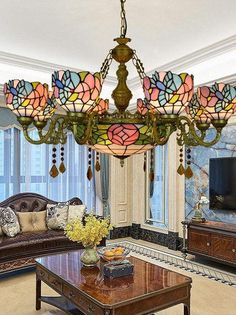 a living room filled with furniture and a large stained glass chandelier hanging from the ceiling