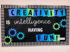 a bulletin board with the words creativity is inteliligence having fun written on it