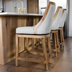 two wooden stools sitting in front of an island