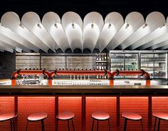 an empty bar with several stools in front of it