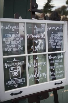 a sign that has been placed in front of a window with the words welcome to our wedding written on it