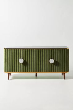 a green cabinet with two white knobs on it