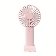 a pink fan sitting on top of a white surface