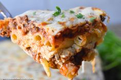 a fork full of lasagna casserole with meat and cheese on it