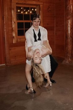 a man and woman are doing acrobatic tricks on the dancefloor