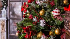 a decorated christmas tree with red and gold ornaments