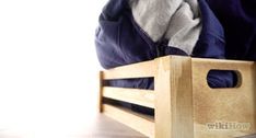 a person sitting on a wooden bench with their feet propped up against the backrest