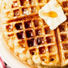 waffles with syrup and butter on a white plate