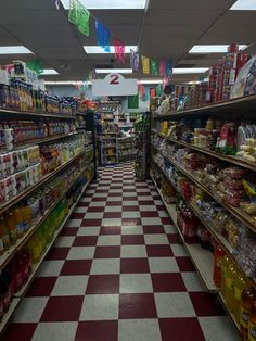 an aisle in a grocery store filled with lots of food and condiments on the shelves